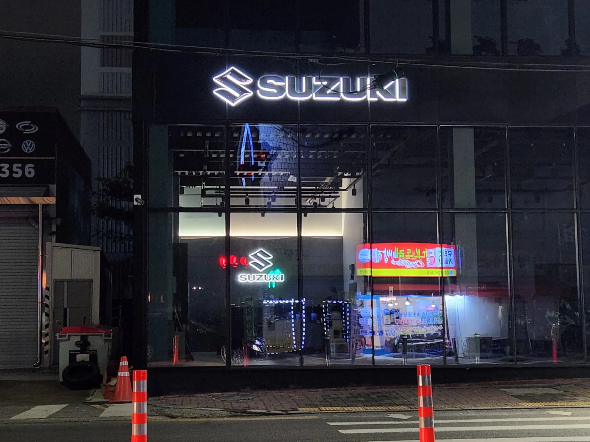 스즈키월드 천안 매장 출입구 SUZUKI 간판 야간 점등 전경